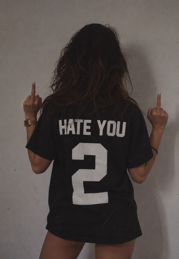 Black women's Hate You 2 T-shirt featuring a bold white rebellious slogan printed on the back.