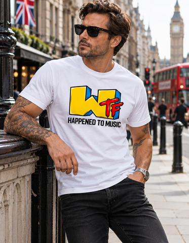 A man wearing a white graphic t-shirt with a yellow, blue, and red 'WTF' logo and the text 'HAPPENED TO MUSIC' leans against a London street railing, with Big Ben and a red double-decker bus in the background.