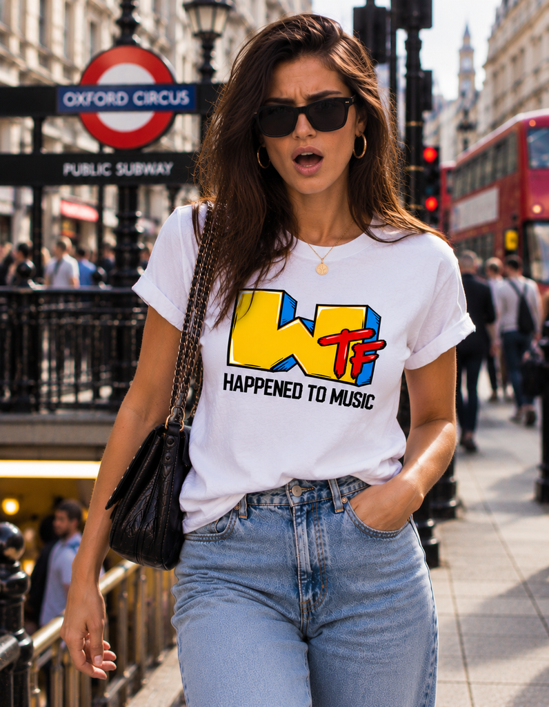 Woman wearing a white WTF Happened to Music retro graphic T-shirt with colourful lettering, standing near Oxford Circus in London.
